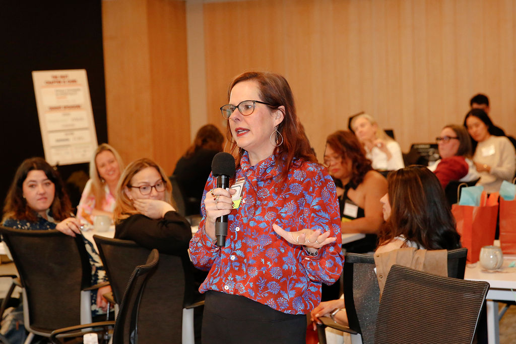 A member speaks into a microphone during an FFiH workshop session